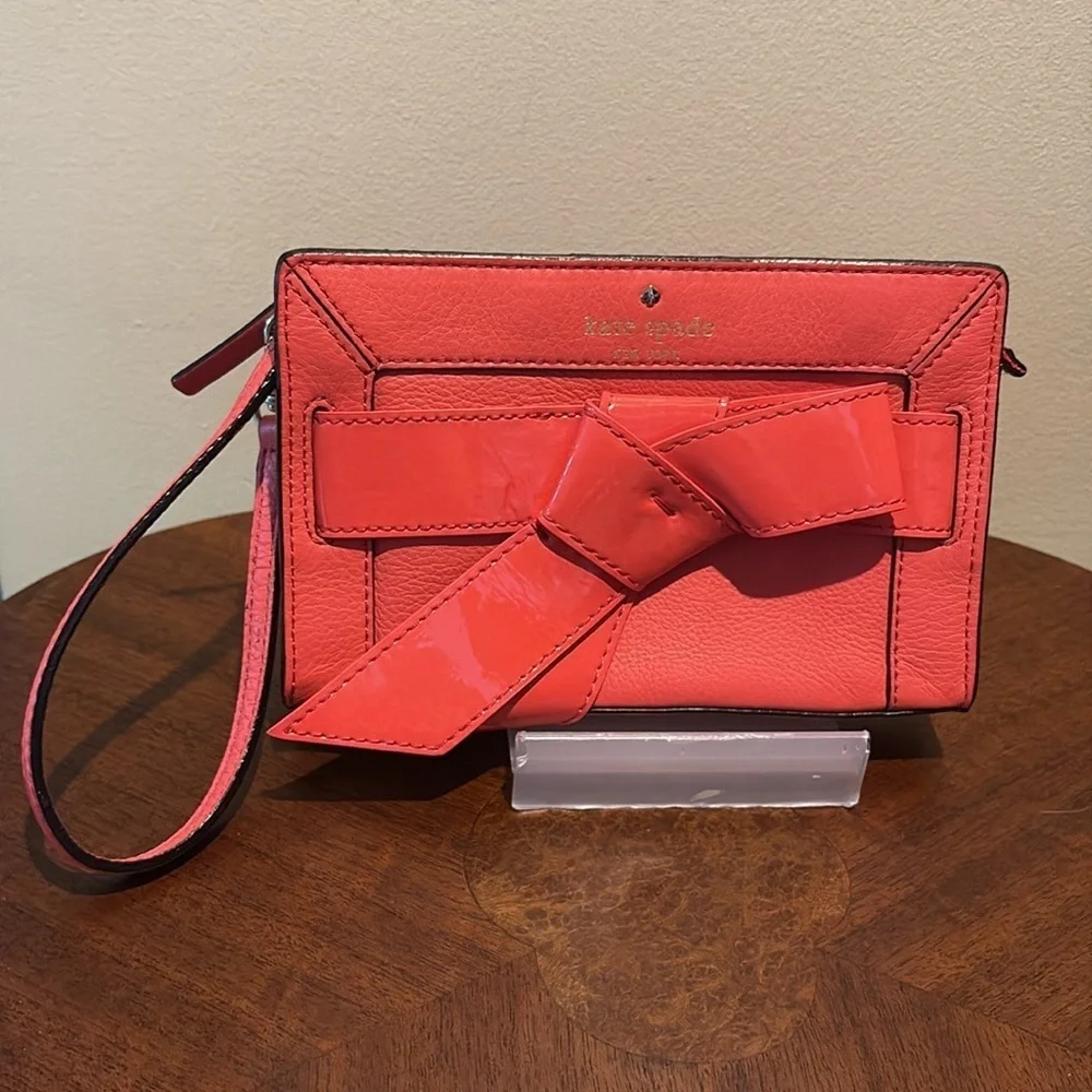 Kate Spade wristlet  pebble leather/patent bow on front  orangeish red gold NWOT